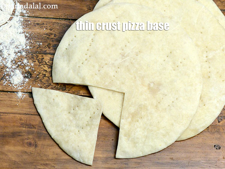 Step 6 – Learn <a href="https://www.tarladalal.com/thin-crust-pizza-base-32421r" target="_blank"><strong>how to make thin pizza at home base in detail</strong></a>.&nbsp;
