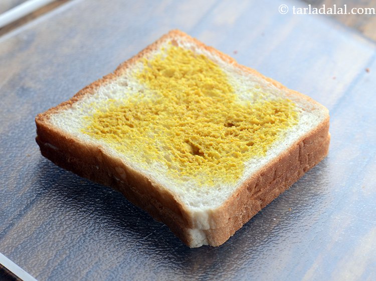 Step 6 – Spread &frac12; tsp mustard sauce.