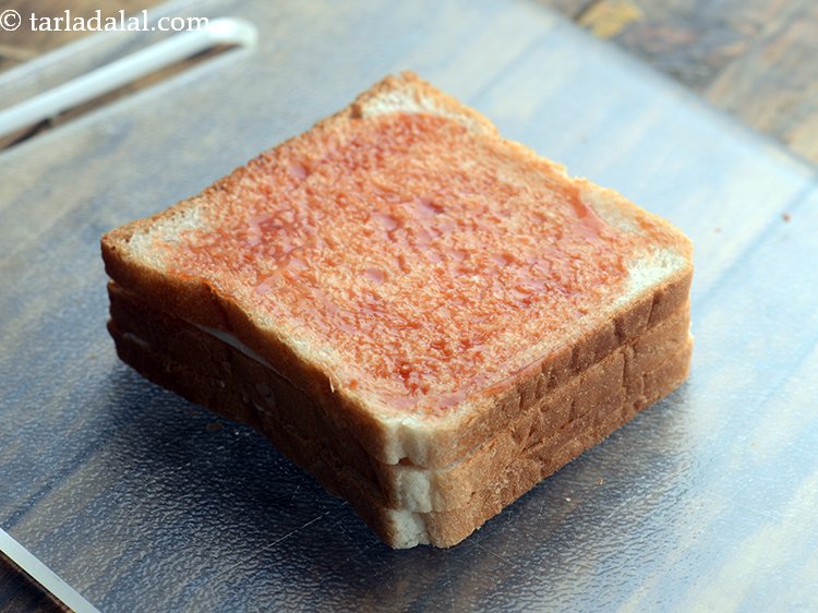 Step 9 – Spread 1 tsp of tomato ketchup evenly.&nbsp;