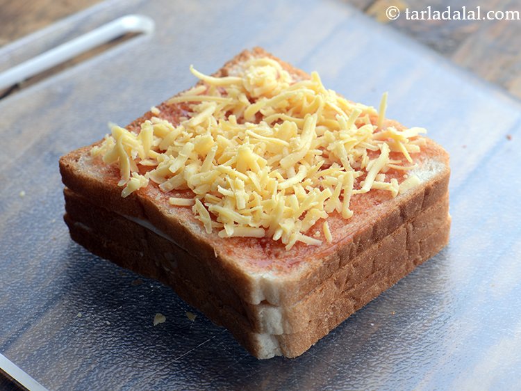 Step 10 – Sprinkle 2 tbsp of cheese and a little mixed herbs evenly over it.