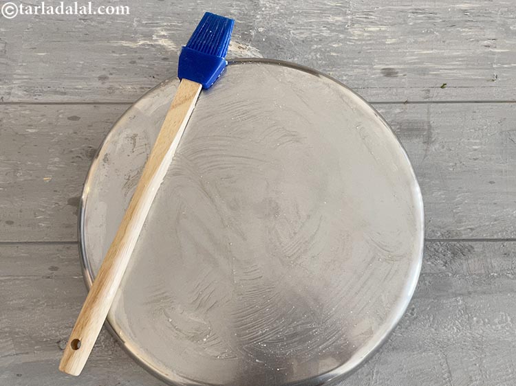 Step 3 – Spread ghee over the thali with a brush. Make sure your entire thali is covered …