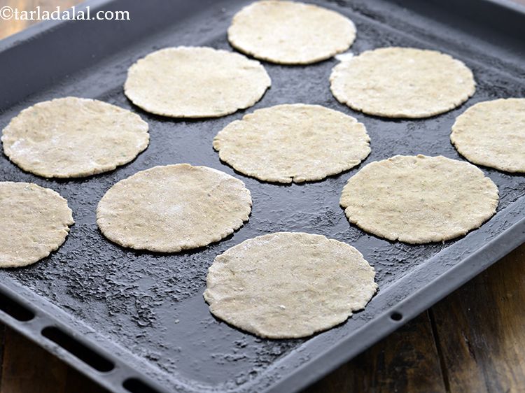 Step 12 – Place half the puris on a greased baking tray.