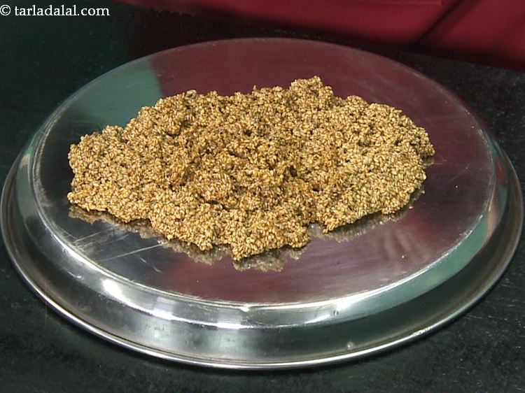 Step 12 – Immediately pour the entire mixture over the back of a greased thali or a smooth …