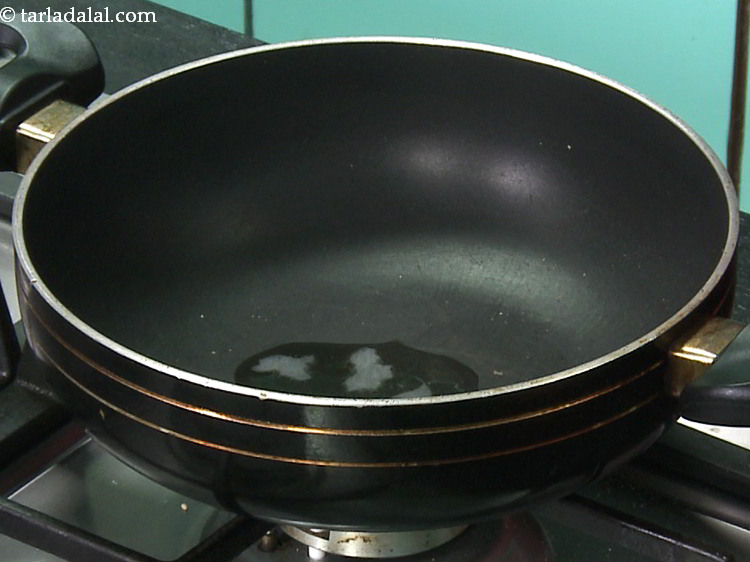 Step 7 – Continue making the <strong>til gur ki chikki</strong>, by heating ghee in the same deep non-stick …