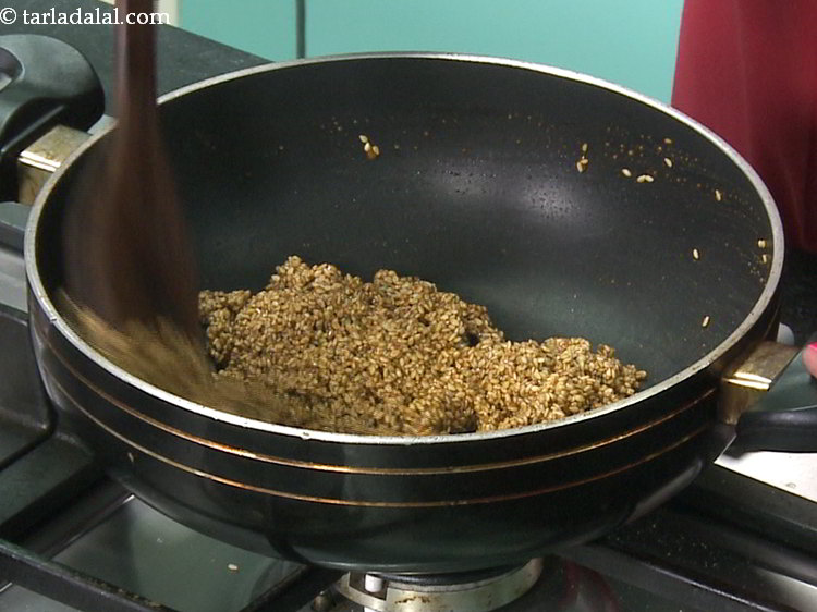 Step 11 – Mix it very well using the same flat ladle. The jaggery and sesame seeds should …