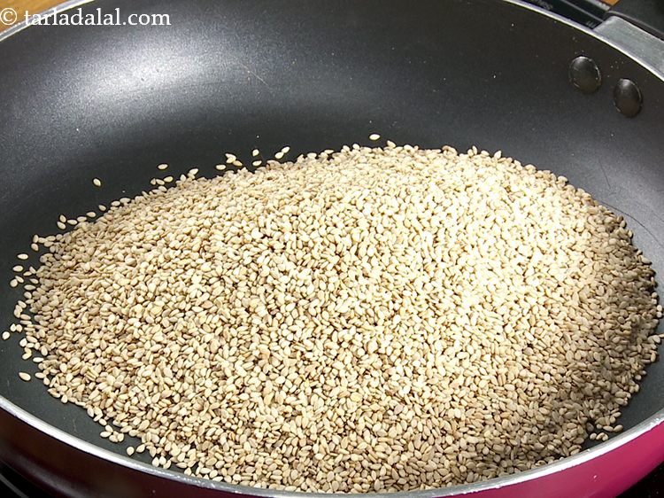 Step 2 – <p>To prepare <strong>til ke laddu</strong>, heat a broad non-stick pan, add the sesame seeds.</p>