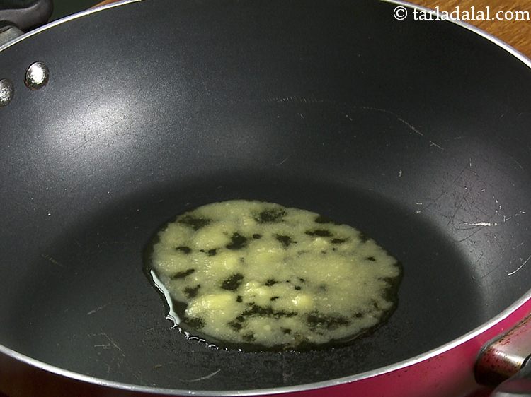Step 5 – <p>To prepare <strong>til ke laddu</strong>, heat the ghee in a deep non-stick pan.</p>