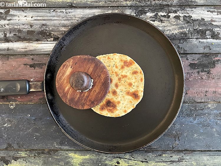 Step 26 – Use a muslin cloth or a khakhra press to apply pressure on the khakhra so …