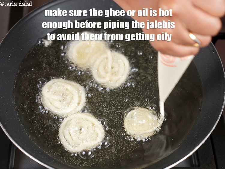 Step 26 – Make sure the ghee or oil is hot enough before piping the jalebis to avoid …
