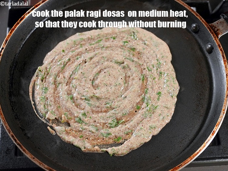 Step 21 – Cook the <meta charset="UTF-8" /><strong>palak ragi dosas</strong>&nbsp; on medium heat, so that they cook through …