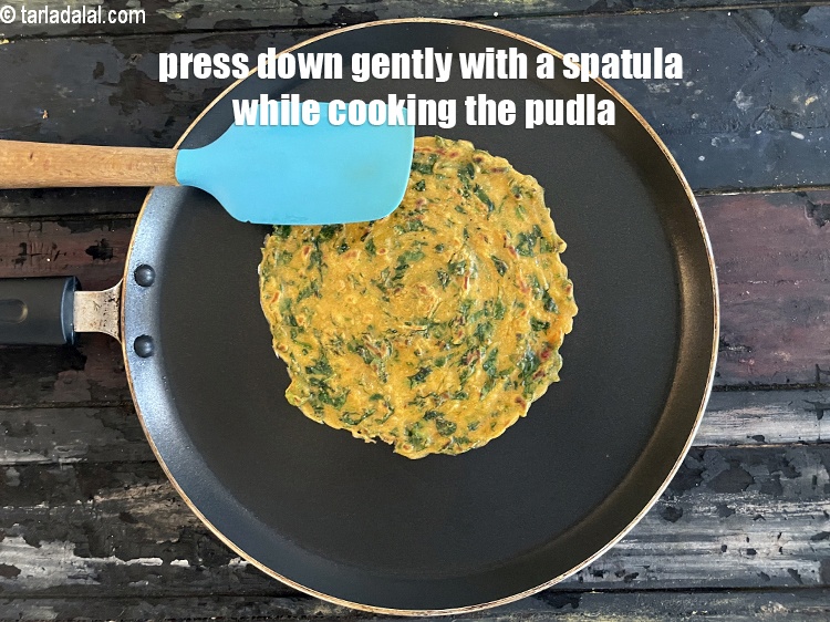 Step 25 – Press down gently with a spatula while cooking the pudla.