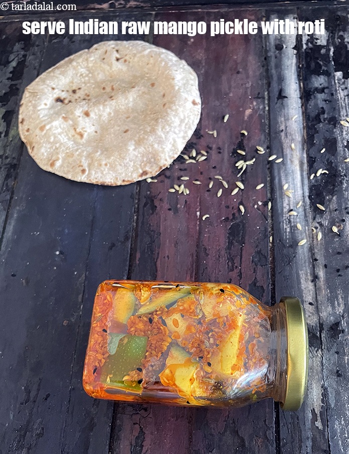 Step 33 – Serve <strong>Indian raw mango pickle </strong>with roti. See <a href="https://www.tarladalal.com/roti--how-to-make-soft-roti-or-phulka-or-chapati-38565r">how to make roti</a>.