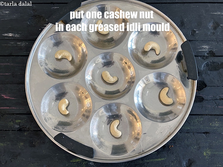 Step 37 – <p>Put one cashew nut in each idli mould.</p>