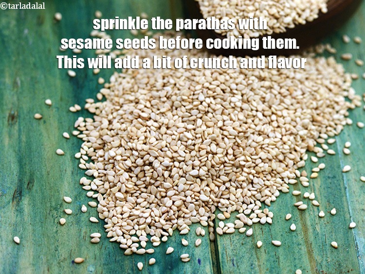 Step 30 – Sprinkle the parathas with sesame seeds before cooking them. This will add a bit of …