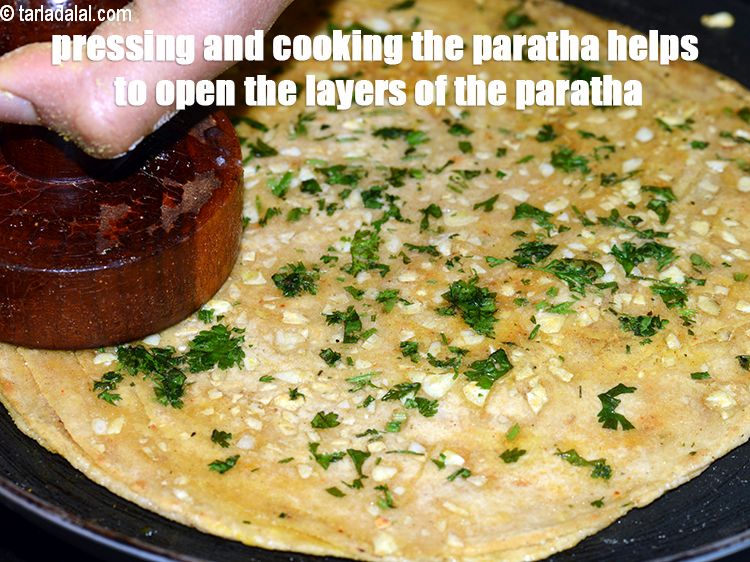 Step 33 – Pressing and cooking the paratha helps to open the layers of the paratha.