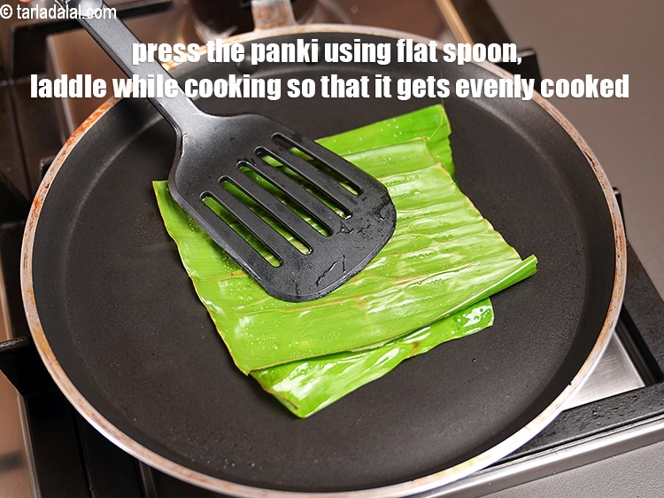 Step 29 – <meta charset="UTF-8" />Press the panki using flat spoon, laddle while cooking so that it gets …
