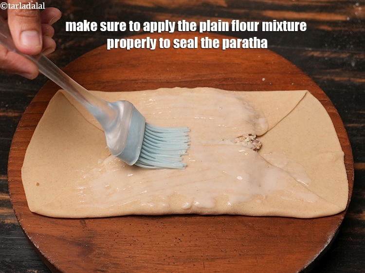 Step 34 – Make sure to apply the plain flour mixture properly to seal the paratha.