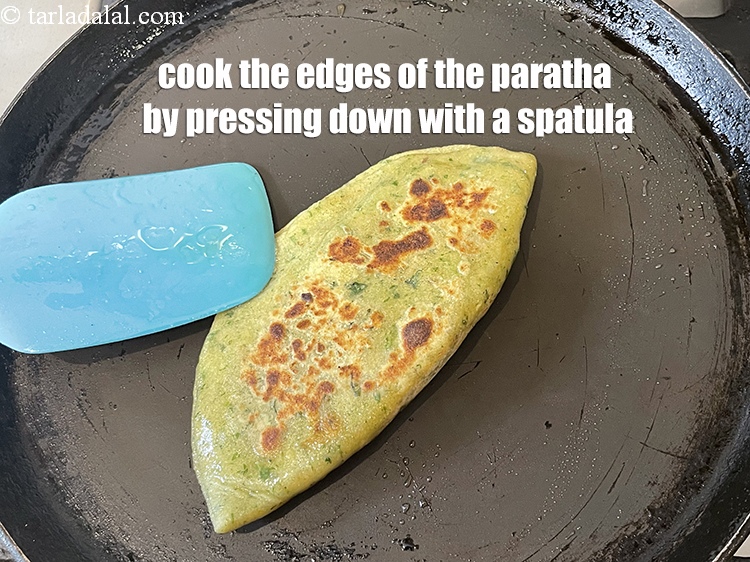 Step 51 – Cook the edges of the paratha by pressing down with a spatula. If you don&#39;t, …
