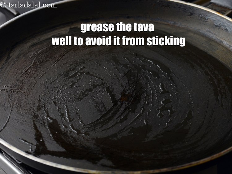Step 25 – Grease the tava well to avoid it from sticking.