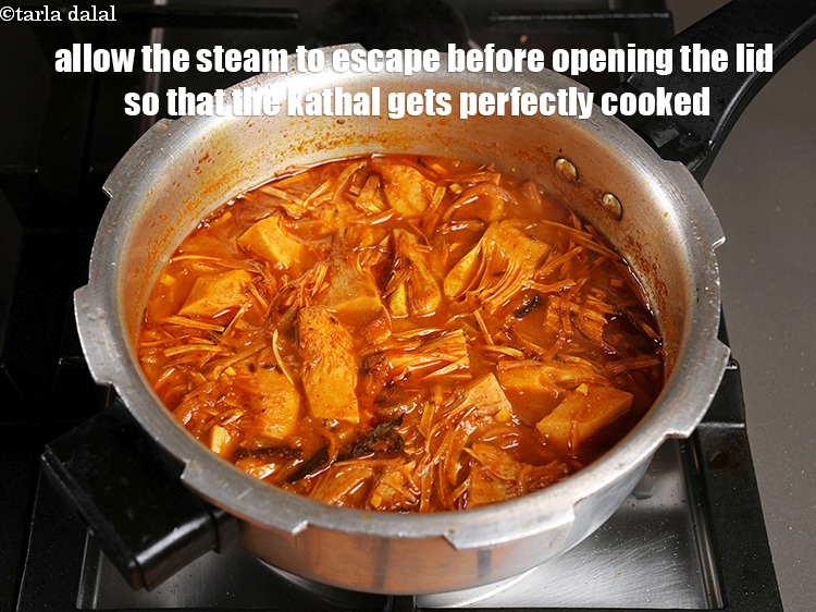 Step 39 – Allow the steam to escape before opening the lid so that the kathal gets perfectly …