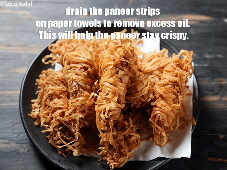 Step 26 – Drain the paneer strips on paper towels to remove excess oil. This will help the …