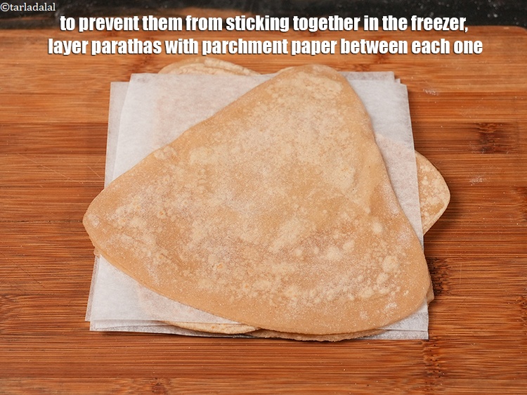Step 29 – To prevent them from sticking together in the freezer, layer parathas with parchment paper between …