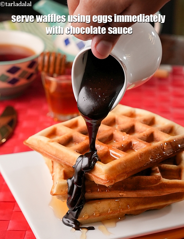 Step 21 – Serve <strong>waffles using eggs recipe&nbsp;|&nbsp;Indian style waffles&nbsp;|&nbsp;classic waffle recipe |</strong> immediately with <a href="https://www.tarladalal.com/glossary-chocolate-sauce-1989i">chocolate sauce</a> …