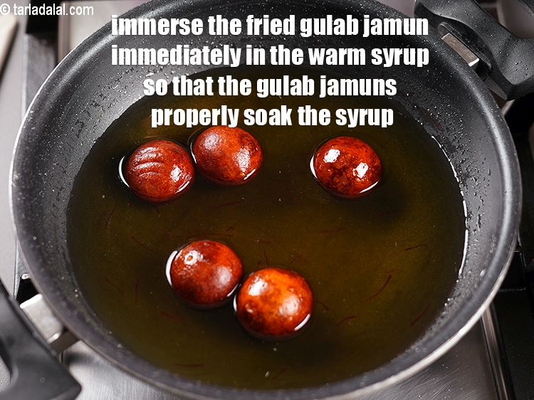 Step 28 – Immerse the fried gulab jamun immediately in the warm syrup so that the gulab jamuns …