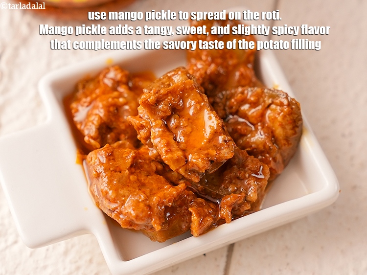 Step 39 – Use <a href="mango-pickle-30931r">mango pickle</a>&nbsp;to spread on the roti.&nbsp;Mango pickle adds a tangy,&nbsp;sweet,&nbsp;and slightly spicy flavor …