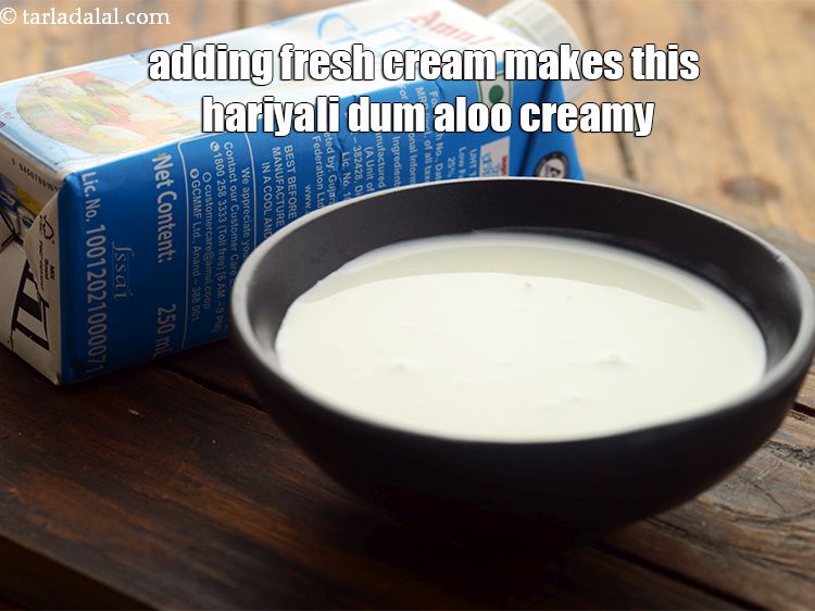 Step 28 – Adding fresh cream makes this hariyali dum aloo creamy.