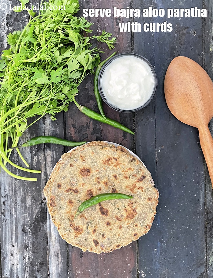 Step 31 – Serve&nbsp;bajra aloo paratha with curds.