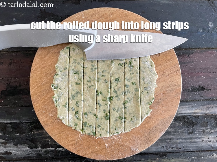 Step 26 – <meta charset="UTF-8" /> Cut the rolled dough&nbsp;into long&nbsp;strips using a sharp knife.