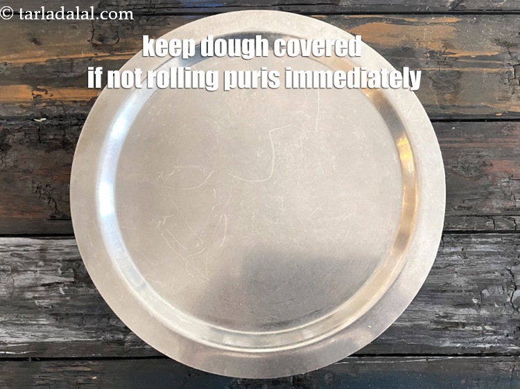 Step 25 – Keep the dough covered if not&nbsp;rolling the puris immediately, so that it does not dry …