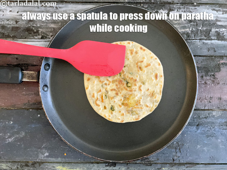 Step 46 – Always use a spaltula and press down while cooking the paratha. This must be done …