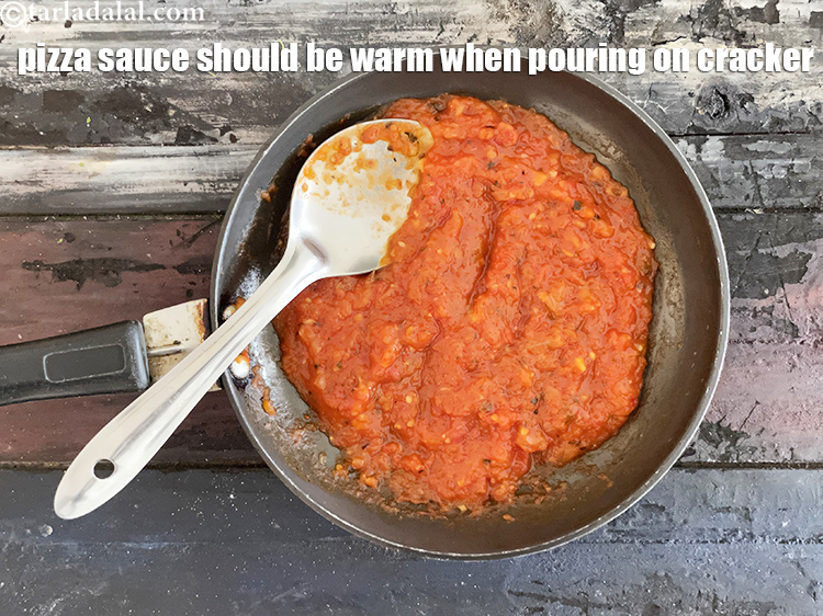 Step 13 – <meta charset="UTF-8" />The pizza sauce must be just warm when pouring on the crackers, because …