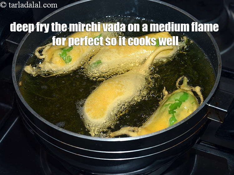 Step 31 – Deep fry the mirchi vada on a medium flame for perfect so it cooks well.