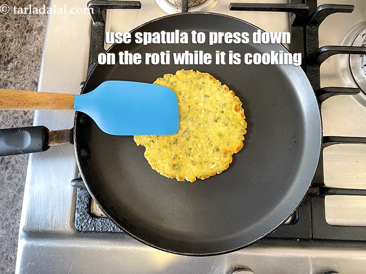 Step 24 – Use a spatula to press down all across&nbsp;the roti while it is being cooked.