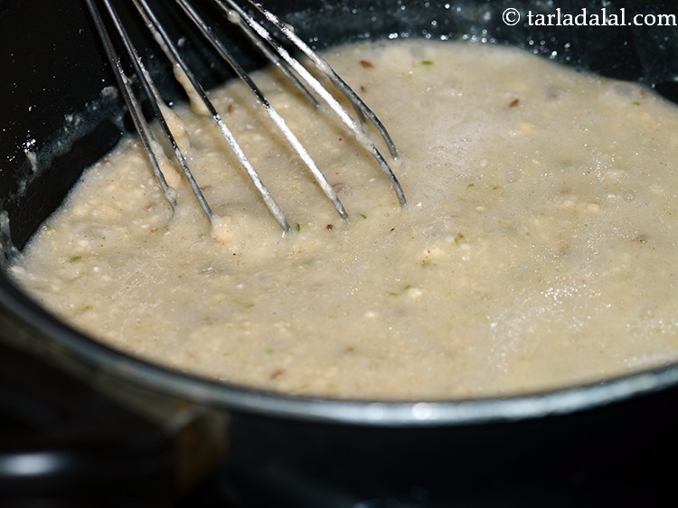Step 17 – After adding jowar flour stir continuously to avoid lumps in khichu.&nbsp;