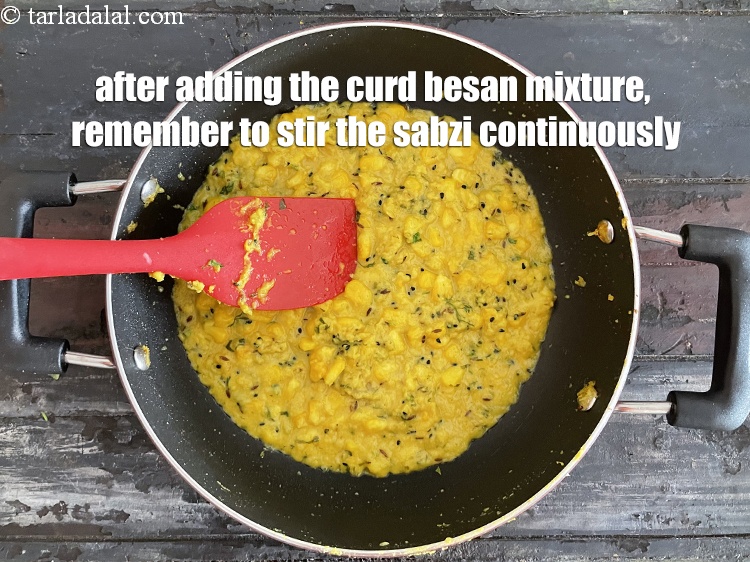 Step 39 – After adding the curd besan mixture, remember to stir the sabzi continuously so the curd …