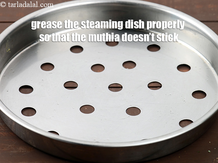 Step 28 – Grease the steaming dish properly so that the muthia doesn&rsquo;t stick.