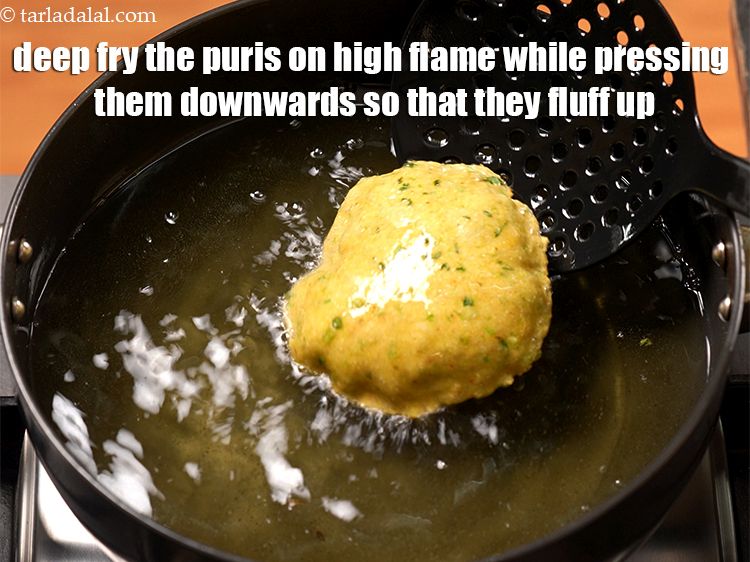 Step 19 – Deep fry the puris on high flame while pressing them downwards so that they fluff …