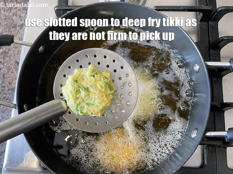 Step 24 – Since tikkis are not firm before frying, place each tikki on a slotted spoon ( …