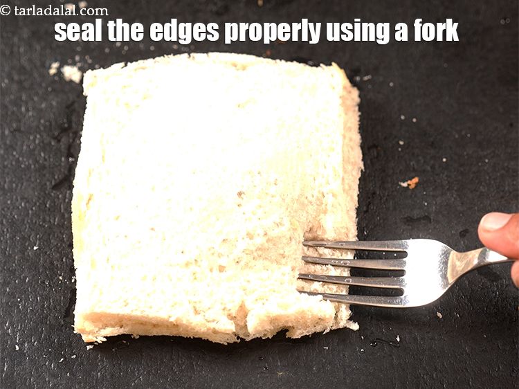 Step 26 – Seal the edges properly using a fork so that the puff doesn&rsquo;t open while frying.