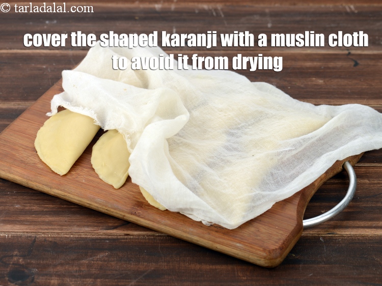Step 54 – Cover the shaped karanji with a muslin cloth to avoid it from drying.