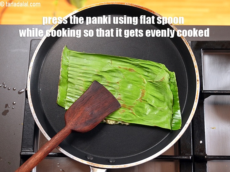 Step 42 – Press the panki using flat spoon while cooking so that it gets evenly cooked.