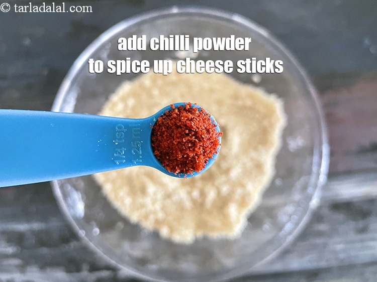 Step 33 – You can add 1/4 tsp chilli powder to spice up <strong>eggless Indian cheese sticks</strong>.