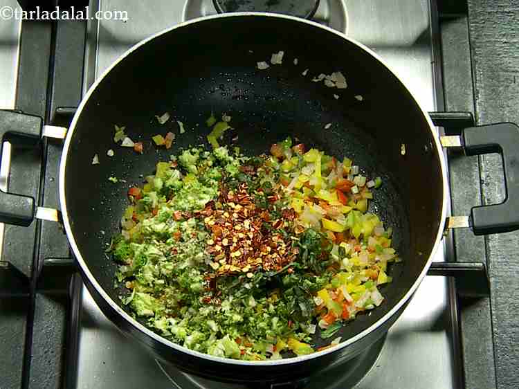 Step 11 – We will now add the dried herbs ? oregano and chilli flakes. Both these herbs …