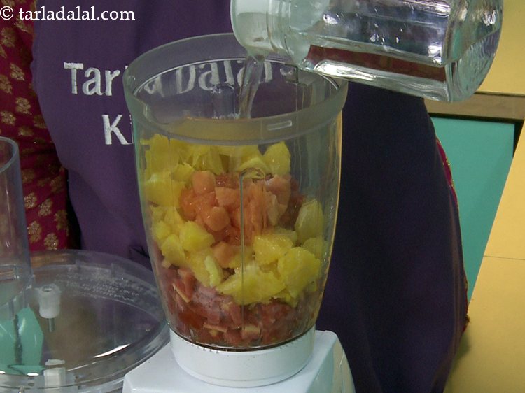 Step 8 – Add &frac34; cup of water to adjust the consistency of the <strong>orange carrot papaya juice</strong>.