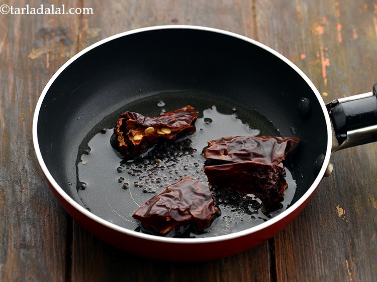 Step 18 – When the seeds crackle, add the red chillies and saut&eacute; on a medium flame for …