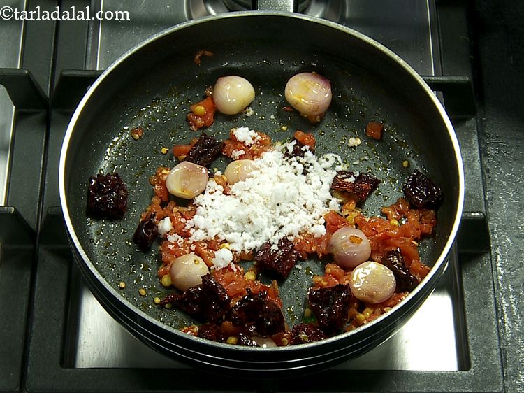 Step 12 – Add the coconut. We have use freshly grated coconut. To grate the coconut quickly, toss …